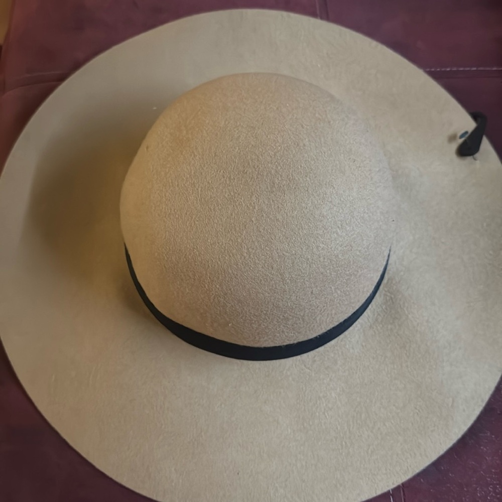 Tan hat with black ribbon
